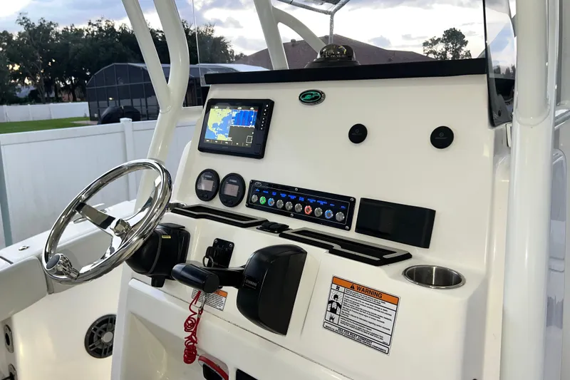Slide: The Image of 2024 Sea Fox 228 Commander boat dashboard with steering wheel and navigation display. - 25