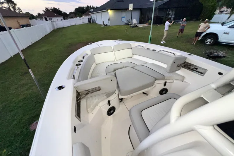 Slide: The Image of 2024 Sea Fox 228 Commander boat interior with cushioned seating in a backyard setting. - 28