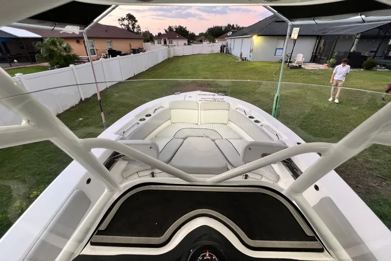 Slide: The Image of 2024 Sea Fox 228 Commander boat parked in a residential backyard setting. - 43