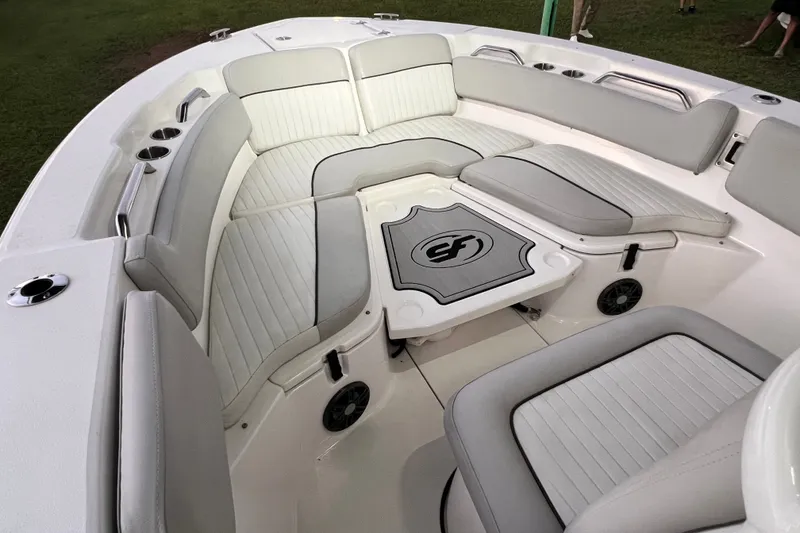 Slide: The Image of 2024 Sea Fox 228 Commander boat interior with cushioned seating and cup holders. - 54