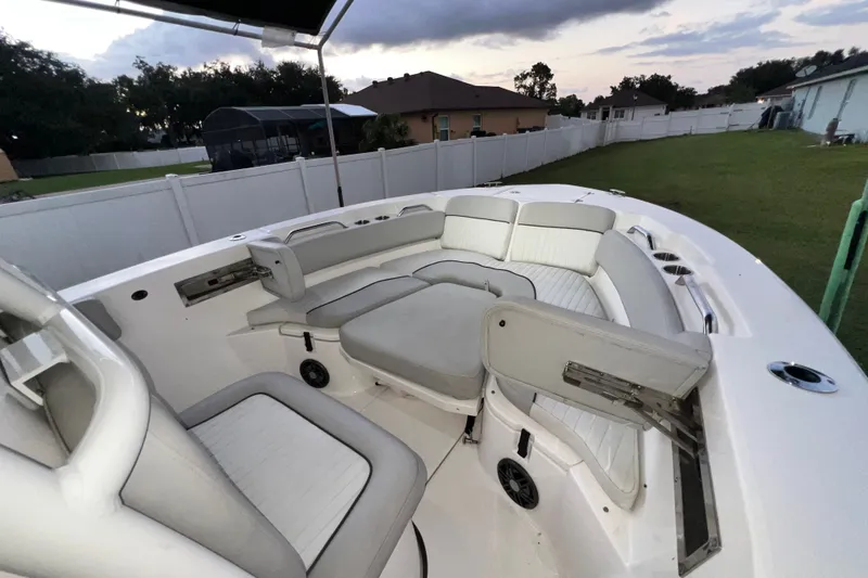 Slide: The Image of 2024 Sea Fox 228 Commander boat interior with cushioned seating and cup holders. - 31