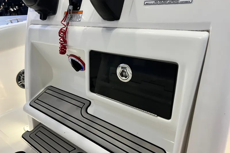 Slide: The Image of 2024 Sea Fox 228 Commander boat dashboard with control panel and safety features. - 66