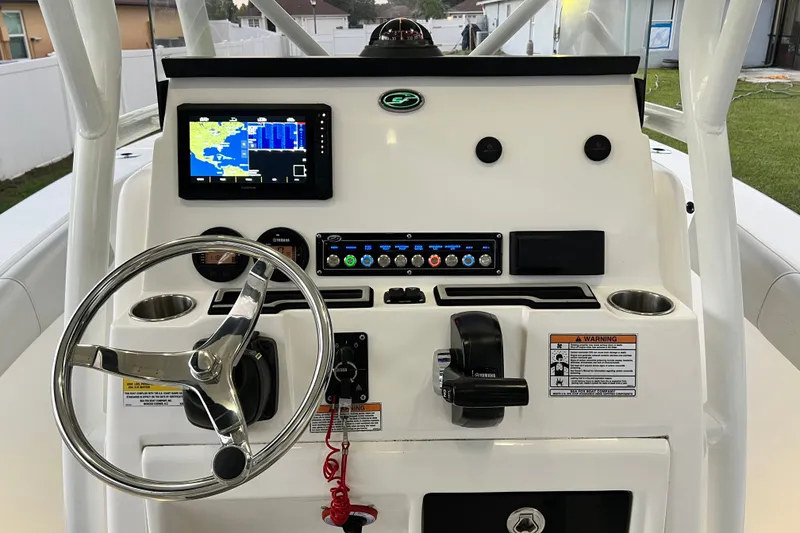 Slide: The Image of 2024 Sea Fox 228 Commander boat dashboard with steering wheel, navigation screen, and controls. - 22