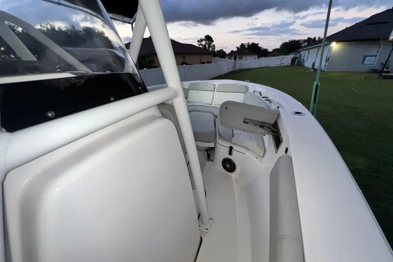 Slide: The Image of 2024 Sea Fox 228 Commander boat interior at dusk, showcasing seating and console. - 30