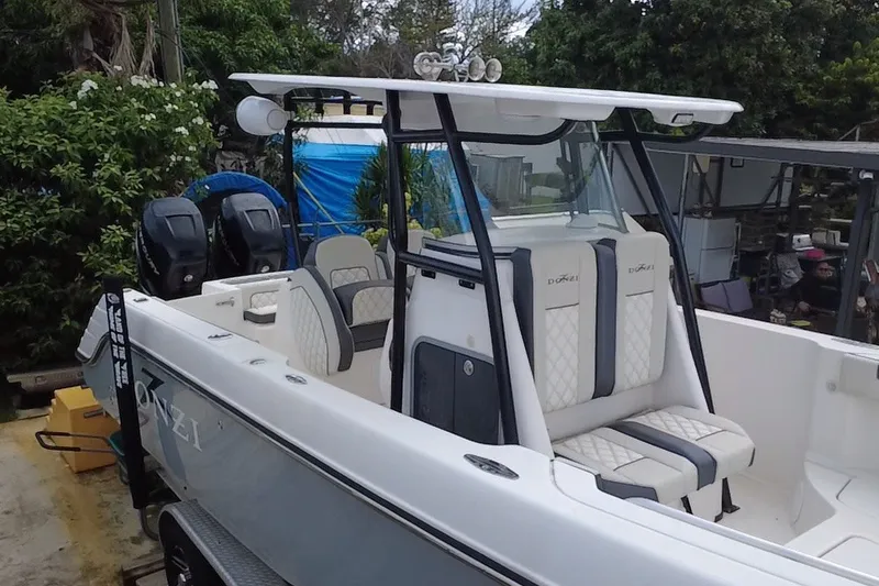 Slide: The Image of 2011 Donzi 29 ZF Open boat with dual engines, white seating, and sleek design. - 12
