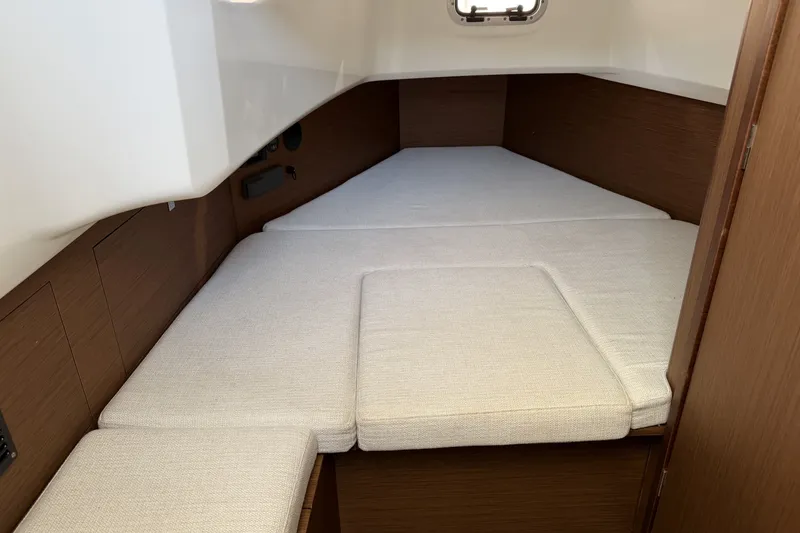 Slide: The Image of 2022 Jeanneau Leader 9.0 CC cabin interior with cushioned sleeping area. - 18