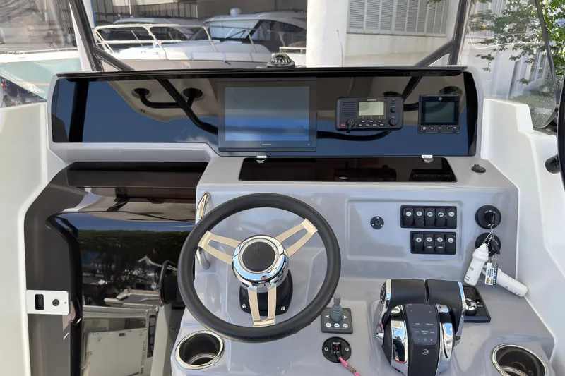 Slide: The Image of 2022 Jeanneau Leader 9.0 CC helm with modern controls and navigation equipment. - 17
