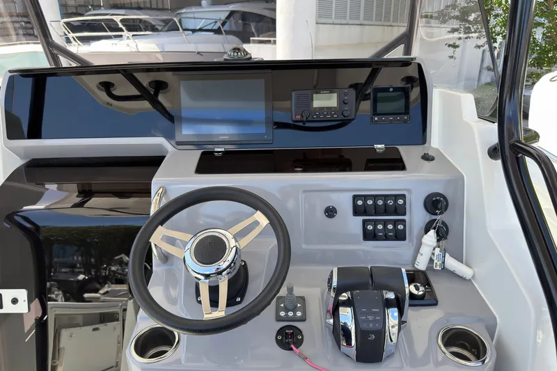 Slide: The Image of 2022 Jeanneau Leader 9.0 CC helm with modern controls and navigation equipment. - 16