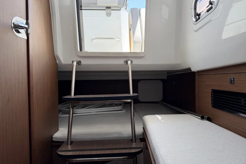 Slide: The Image of Interior cabin of 2022 Jeanneau Leader 9.0 CC boat with wooden accents and seating. - 21