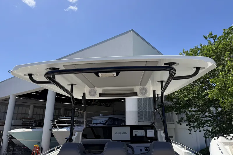 Slide: The Image of 2022 Jeanneau Leader 9.0 CC boat with T-top and Garmin electronics, docked outdoors. - 31