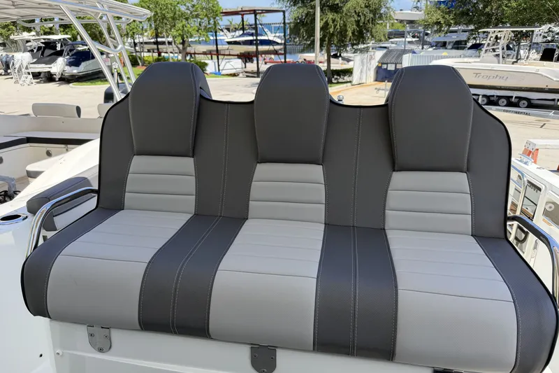 Slide: The Image of 2022 Jeanneau Leader 9.0 CC boat seating, featuring sleek gray and black upholstery. - 23