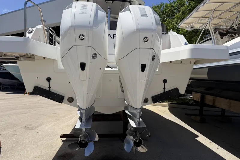 Slide: The Image of 2022 Jeanneau Leader 9.0 CC with dual outboard engines, docked on a sunny day. - 33