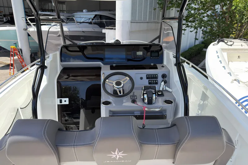 Slide: The Image of 2022 Jeanneau Leader 9.0 CC boat cockpit with steering wheel and controls. - 15