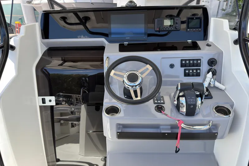Slide: The Image of 2022 Jeanneau Leader 9.0 CC helm with modern controls and navigation equipment. - 14
