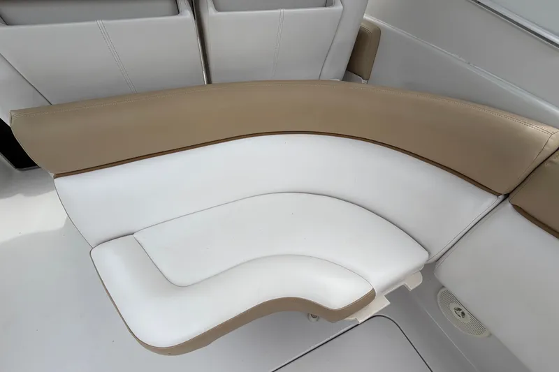 Slide: The Image of 2011 Four Winns V285 boat interior with beige and white seating. - 11