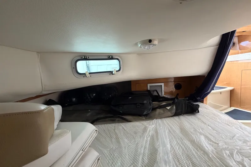 Slide: The Image of Interior cabin of 2011 Four Winns V285 boat with bed and window. - 97