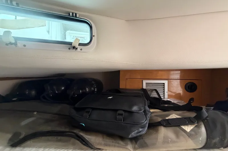 Slide: The Image of Interior cabin of 2011 Four Winns V285 boat with luggage and window view. - 98