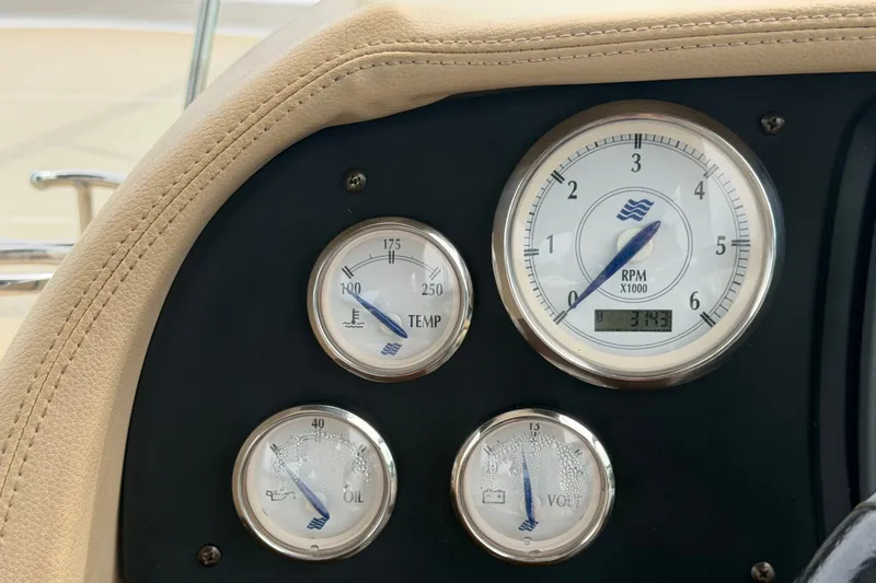 Slide: The Image of Dashboard gauges of a 2011 Four Winns V285 boat, showing RPM, temperature, oil, and voltage. - 23