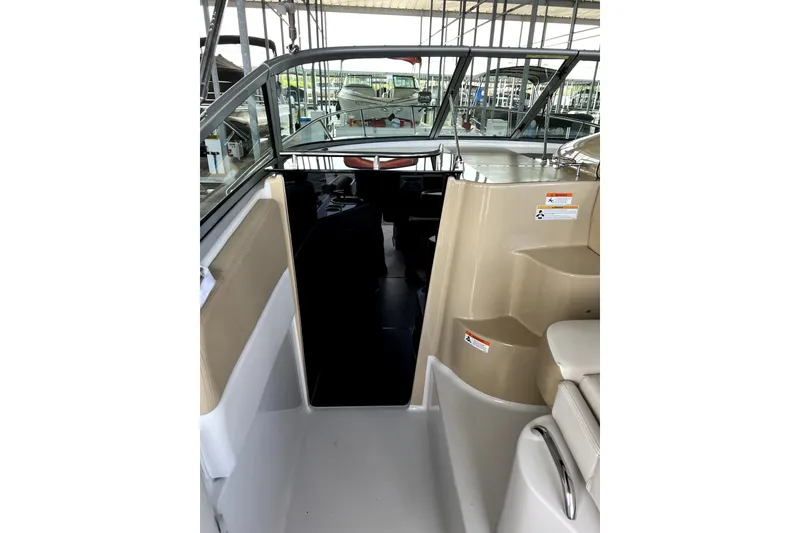 Slide: The Image of 2011 Four Winns V285 boat interior with steps and seating area. - 10