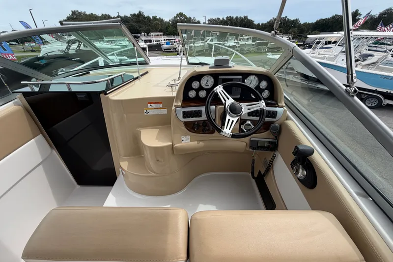 Slide: The Image of 2011 Four Winns V285 boat cockpit with steering wheel and dashboard controls. - 21