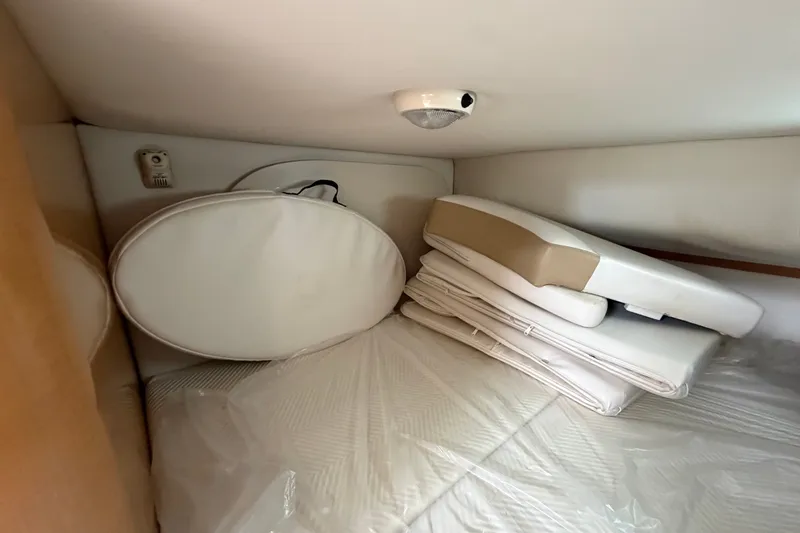 Slide: The Image of Interior cabin storage with cushions in a 2011 Four Winns V285 boat. - 96