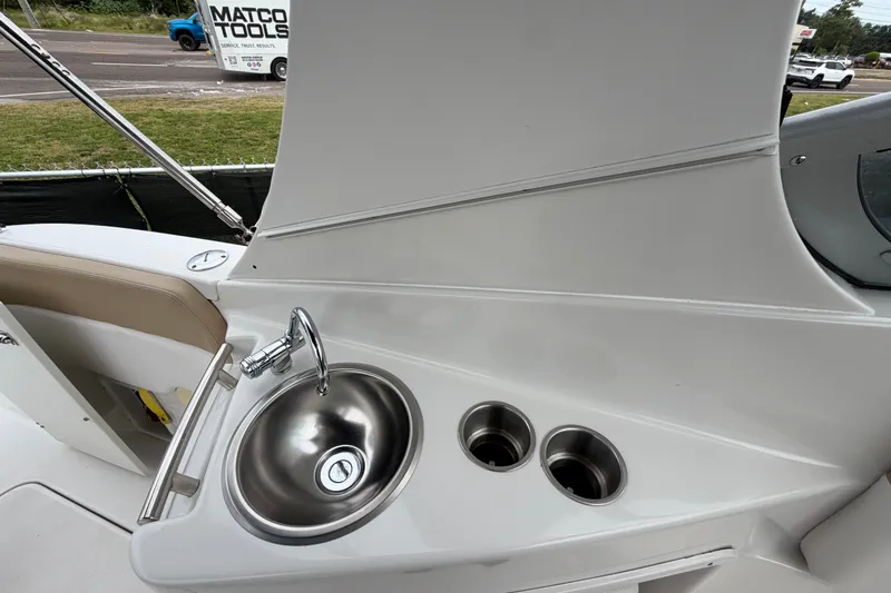 Slide: The Image of 2011 Four Winns V285 boat sink and cup holders on deck. - 14