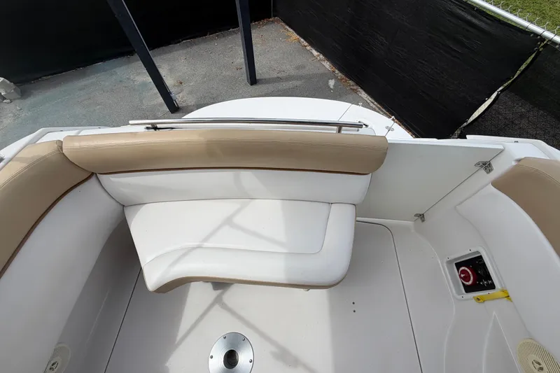 Slide: The Image of 2011 Four Winns V285 boat interior with beige seating and storage compartment. - 112