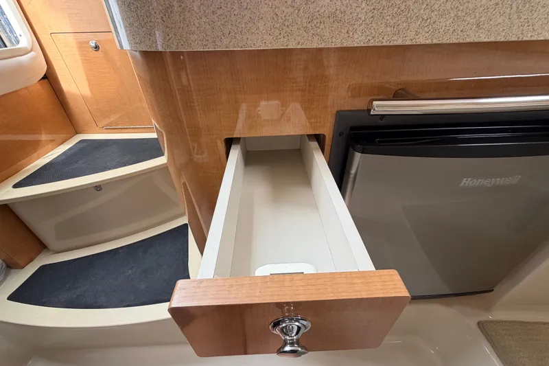 Slide: The Image of 2011 Four Winns V285 interior with open drawer and compact refrigerator. - 65