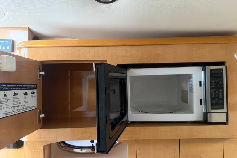 Slide: The Image of Microwave and cabinet in 2011 Four Winns V285 boat interior. - 58