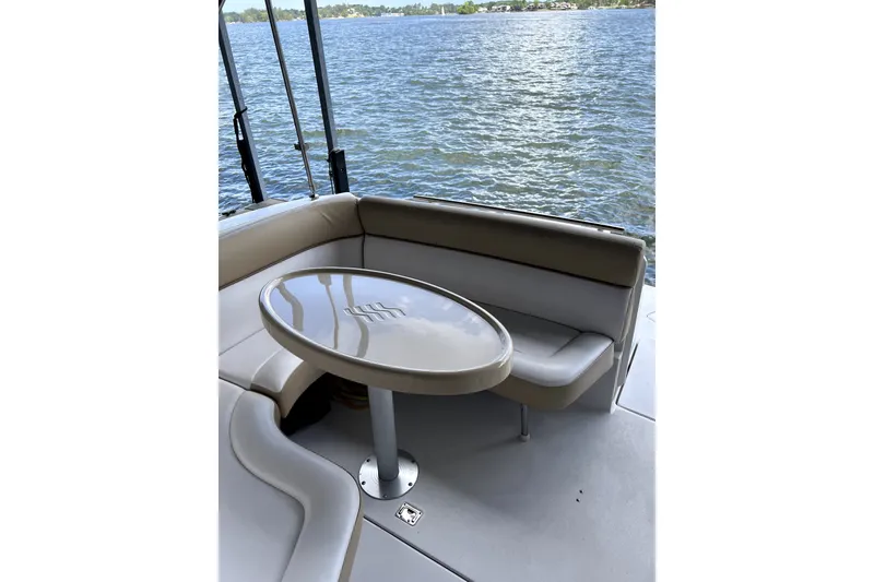 Slide: The Image of 2011 Four Winns V285 boat interior with seating and table by the water. - 9