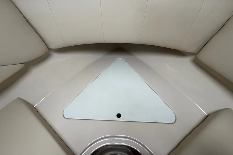Slide: The Image of Interior view of 2011 Four Winns V285 boat cabin with beige seating. - 74