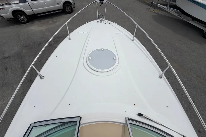 Slide: The Image of 2011 Four Winns V285 boat deck with railing, viewed from above in a parking area. - 32