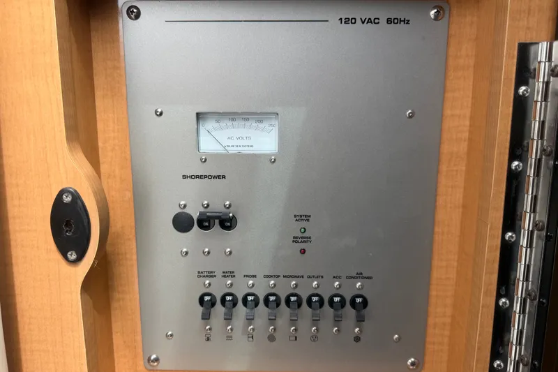 Slide: The Image of Electrical panel on a 2011 Four Winns V285 boat, featuring shore power controls. - 50