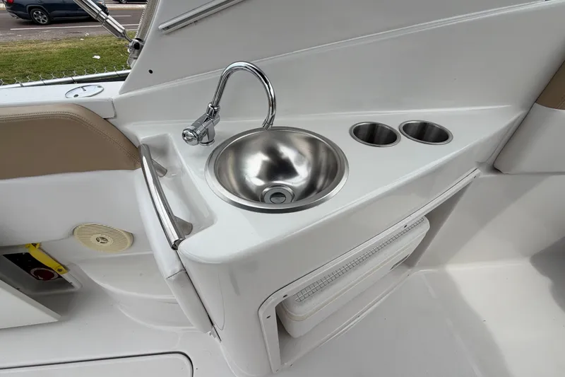 Slide: The Image of 2011 Four Winns V285 boat sink with faucet and cup holders. - 13