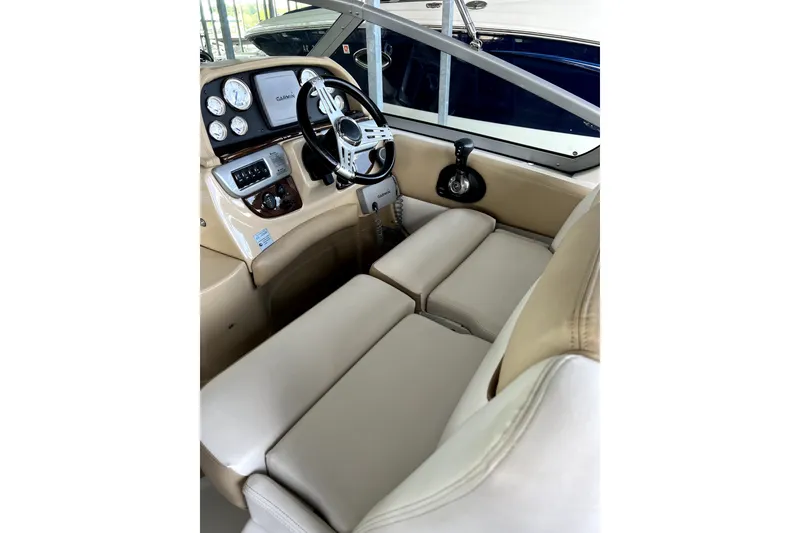Slide: The Image of Interior of 2011 Four Winns V285 boat with beige seating and control panel. - 6