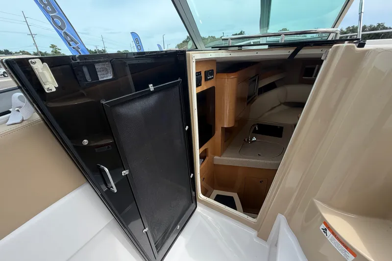 Slide: The Image of 2011 Four Winns V285 cabin interior with kitchenette and seating area. - 43
