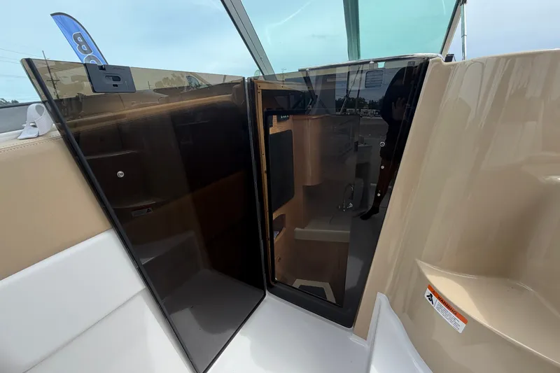 Slide: The Image of 2011 Four Winns V285 boat interior with open cabin door, showcasing sleek design. - 42