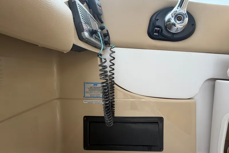 Slide: The Image of Interior view of a 2011 Four Winns V285 boat dashboard with radio and controls. - 19