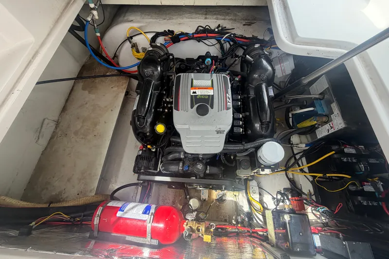 Slide: The Image of Engine compartment of a 2011 Four Winns V285 boat, showcasing detailed wiring and components. - 110