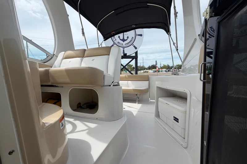 Slide: The Image of 2011 Four Winns V285 boat interior with beige seating and storage compartments. - 101