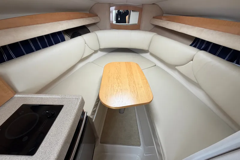 Slide: The Image of Interior of 2011 Four Winns V285 boat with cozy seating and wooden table. - 68