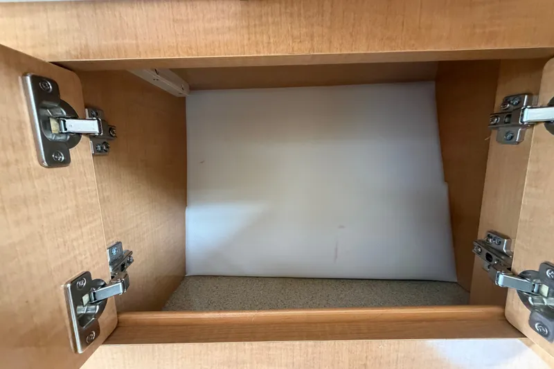 Slide: The Image of Empty wooden cabinet interior on a 2011 Four Winns V285 boat. - 61