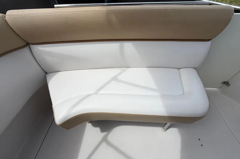 Slide: The Image of 2011 Four Winns V285 boat interior with beige and white cushioned seating. - 111