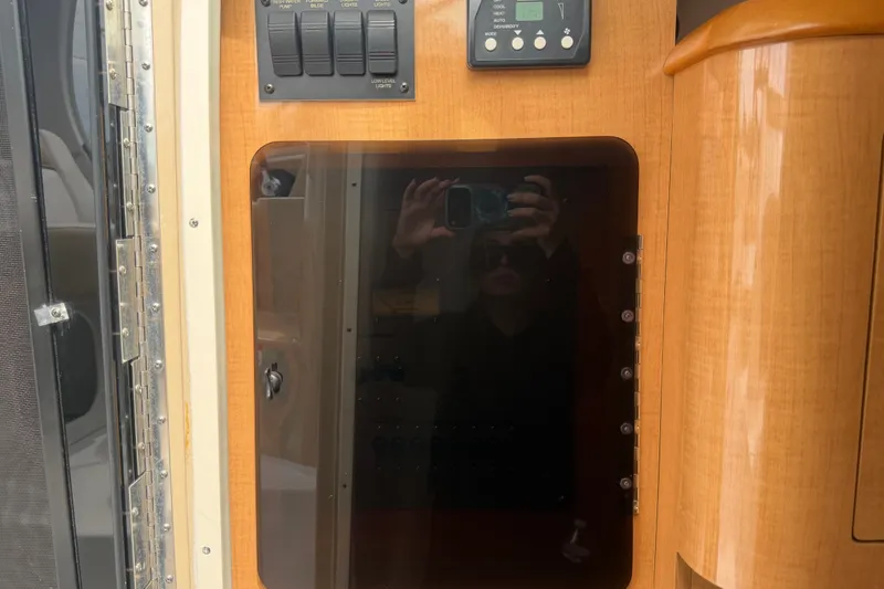 Slide: The Image of Interior control panel of 2011 Four Winns V285 boat with wood finish. - 48