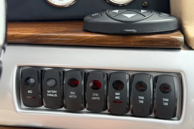 Slide: The Image of Dashboard switches on a 2011 Four Winns V285 boat, featuring various control functions. - 27