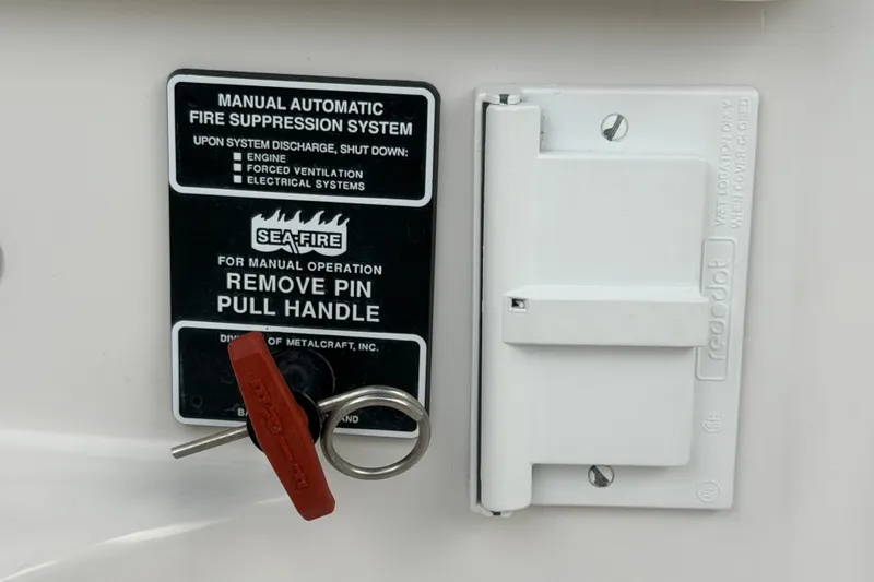 Slide: The Image of Manual fire suppression system on 2011 Four Winns V285 boat with safety instructions. - 115
