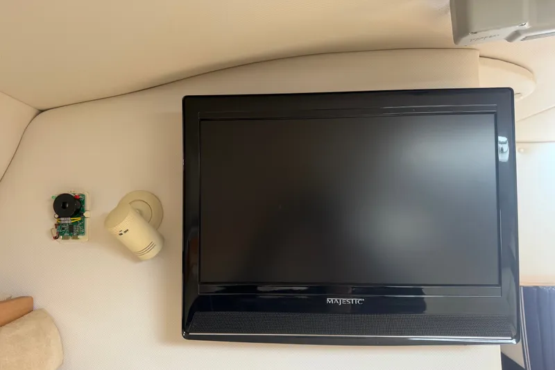 Slide: The Image of Flat-screen TV and electronic components inside 2011 Four Winns V285 boat cabin. - 81