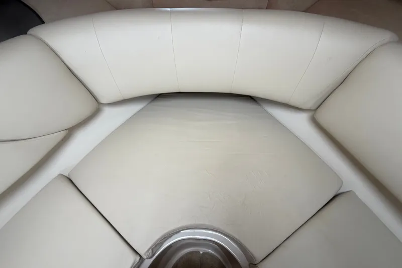 Slide: The Image of Luxurious seating area in a 2011 Four Winns V285 boat, featuring cream upholstery. - 73