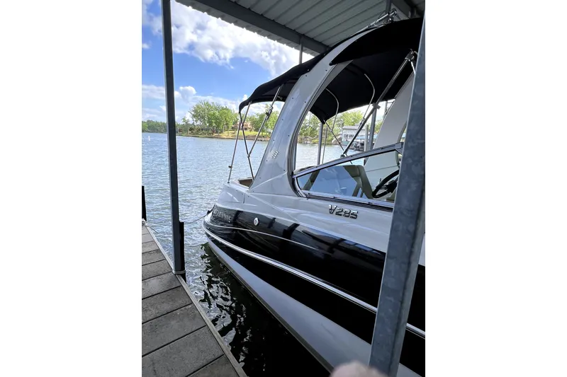 Slide: The Image of 2011 Four Winns V285 boat docked under a canopy on a sunny day. - 5