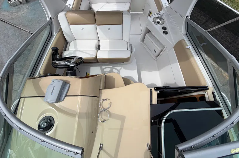 Slide: The Image of The image shows the cockpit of a 2011 Four Winns V285 boat with beige and white seating. - 40